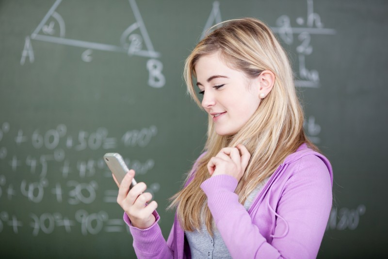 student with smart phone in class