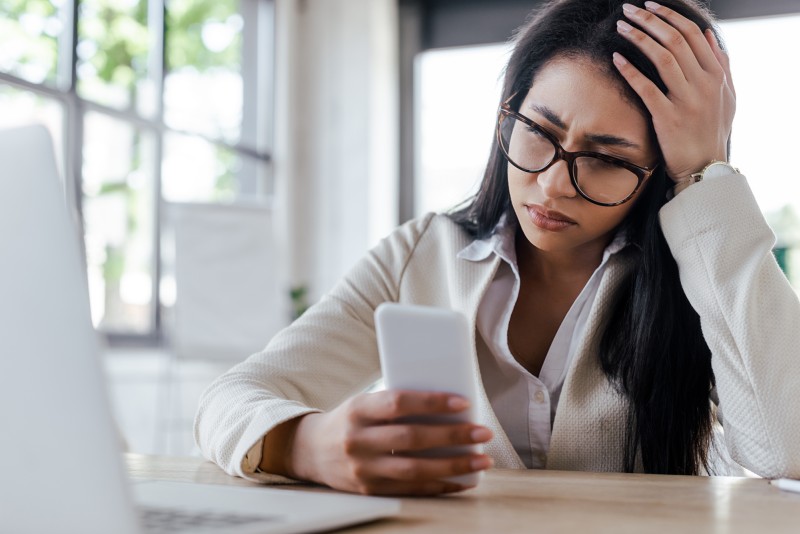 frustrated person looking at phone